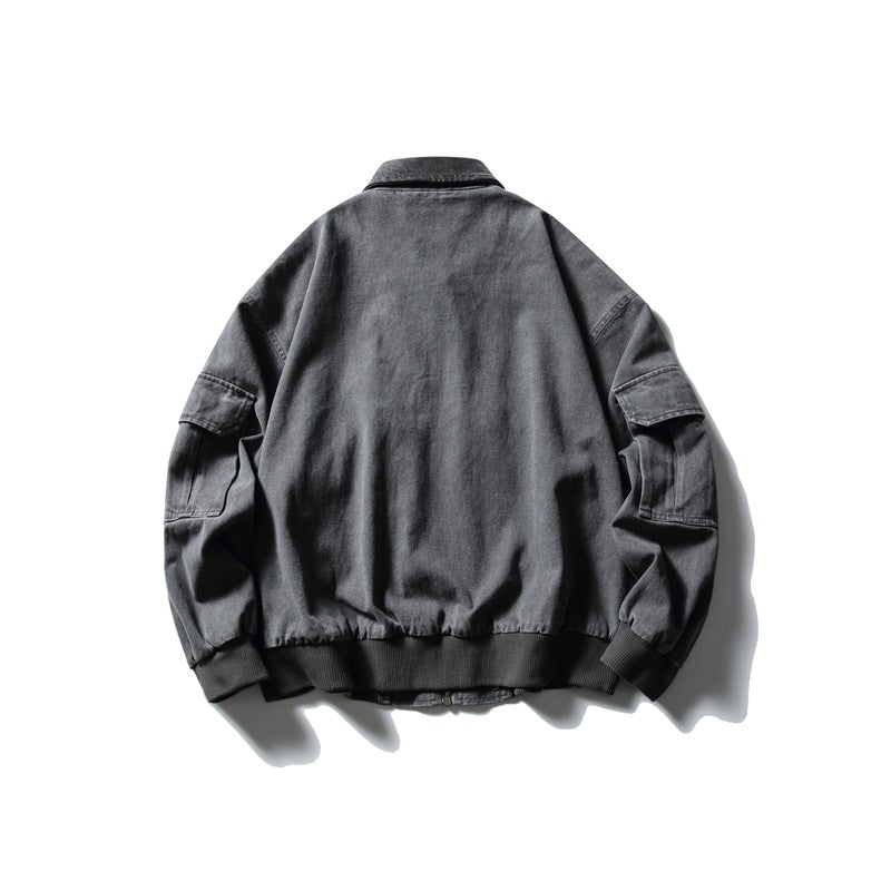 Back view of gray jacket flat lay showing plain back panel, sleeve flap pockets, collar and ribbed cuffs and hem