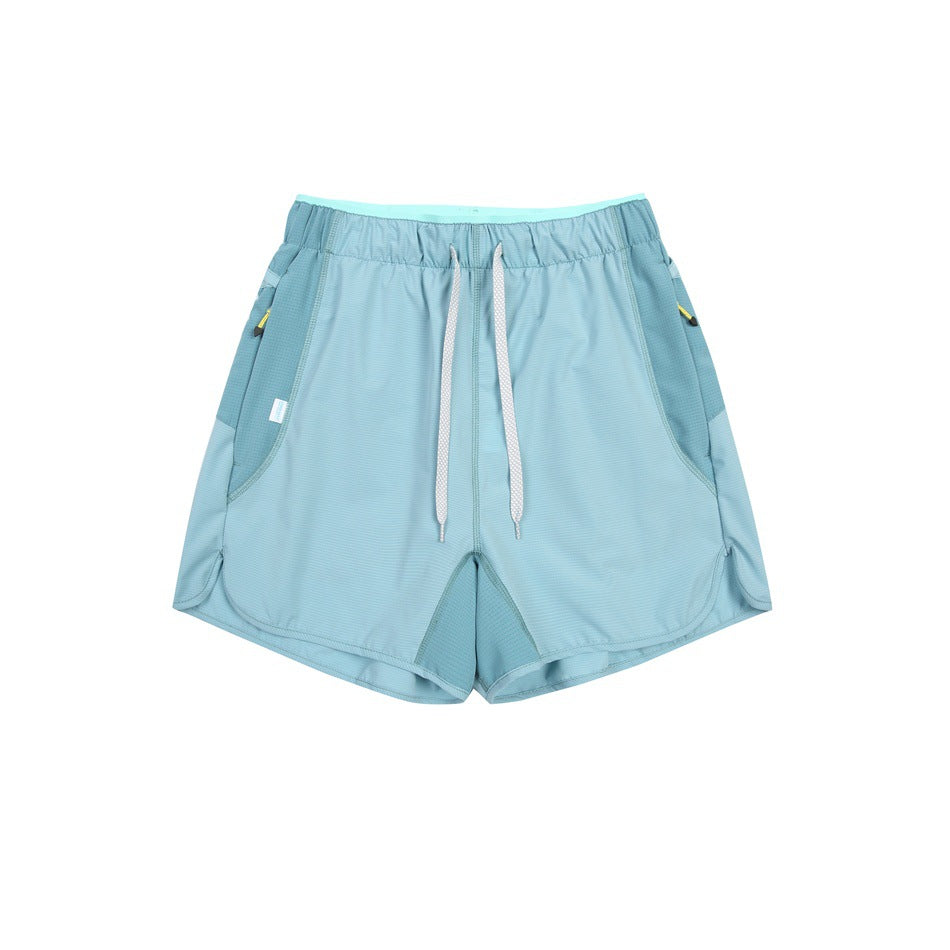 Light teal-blue drawstring shorts with darker teal side panels, flat lay front view