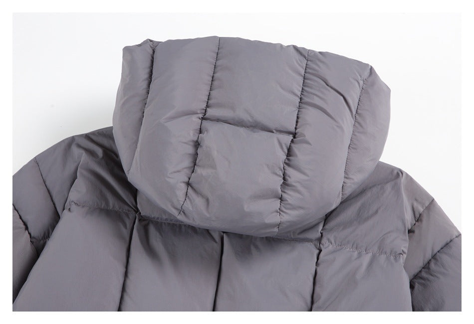 Close-up of the large quilted hood and upper back of a gray puffer jacket.