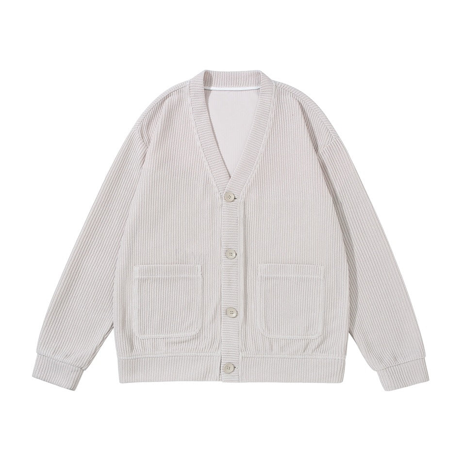 Beige ribbed knit V-neck cardigan with four buttons and two patch pockets, flat front view