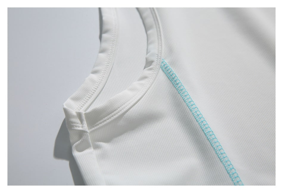 Close-up of a white garment's neckline and turquoise side seam.
