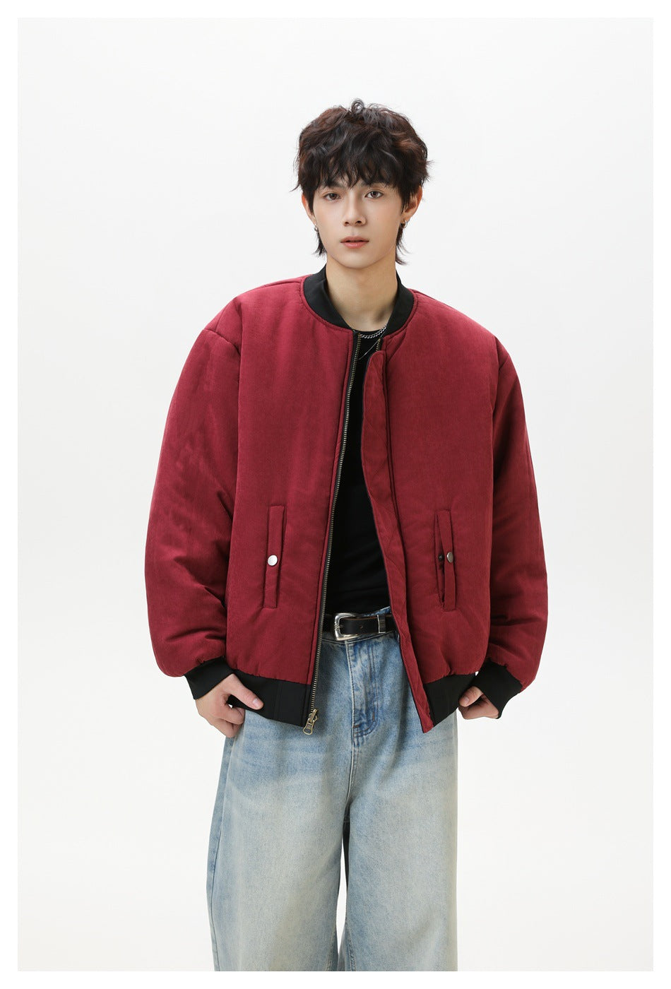 Model wearing a burgundy bomber jacket with black ribbed trim, front zipper and snap pockets.