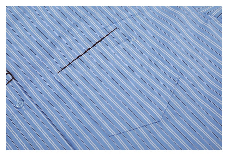 Close-up of the striped shirt's chest pocket and dark diagonal stitching.