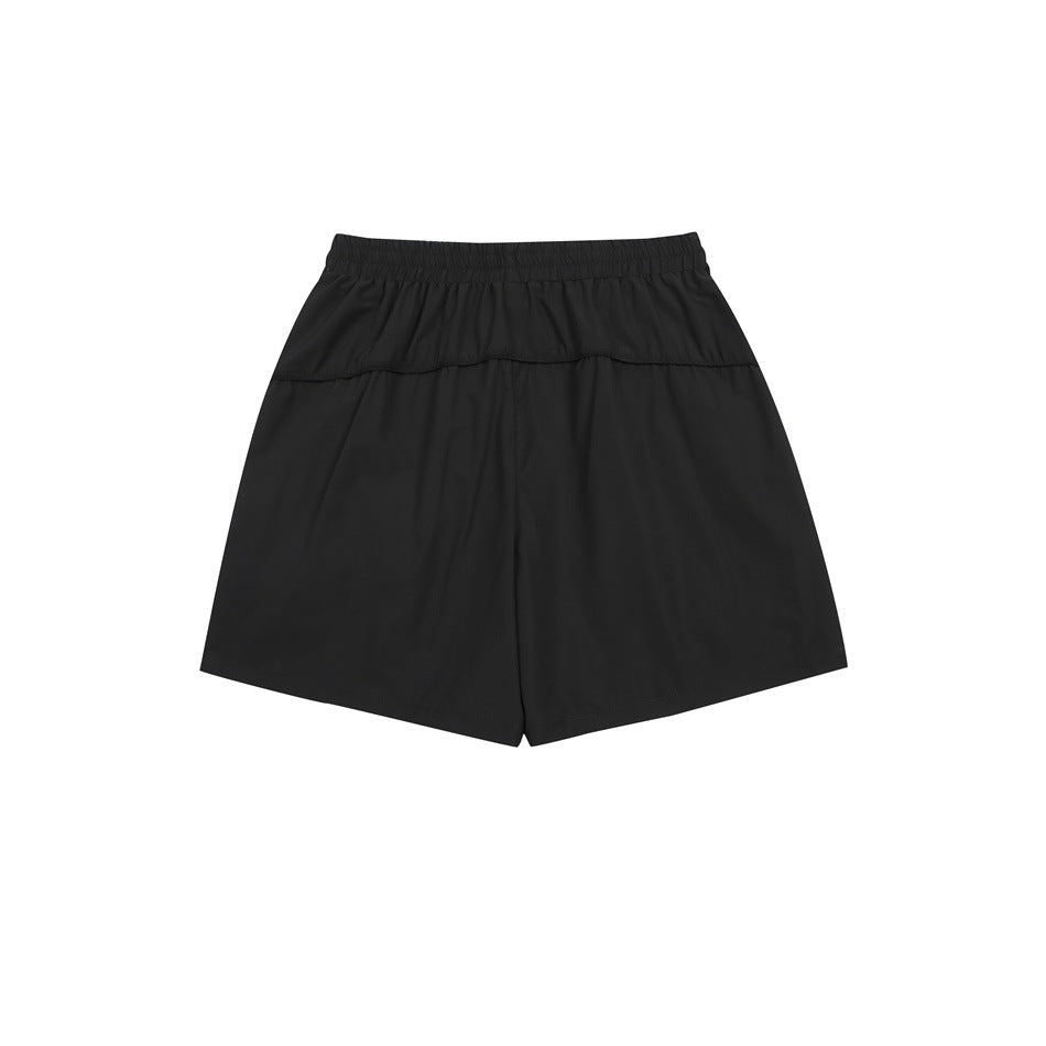 Back view of black athletic shorts with an elastic waistband and horizontal rear seam.