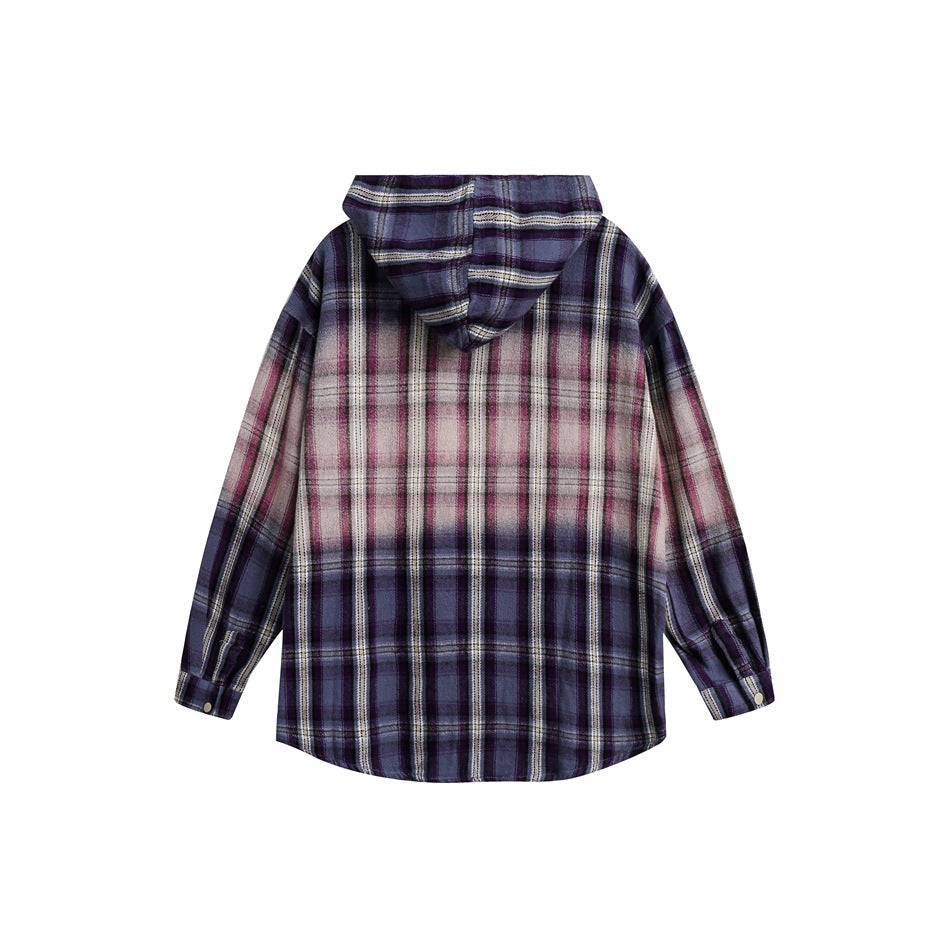 Back view of a purple, gray, and pink plaid hooded shirt with long sleeves and a curved hem, laid flat on white.