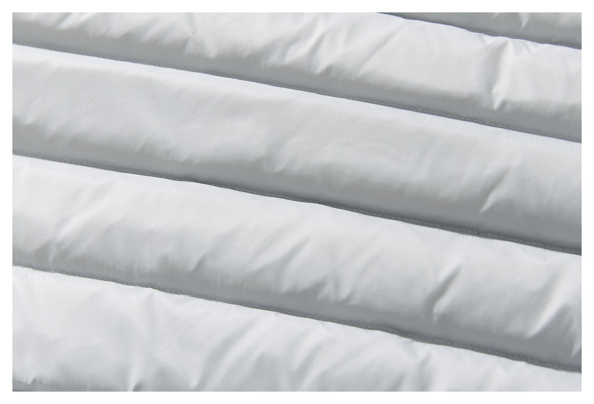 Extreme close-up of the light gray jacket's horizontal quilted panels and fine surface texture.