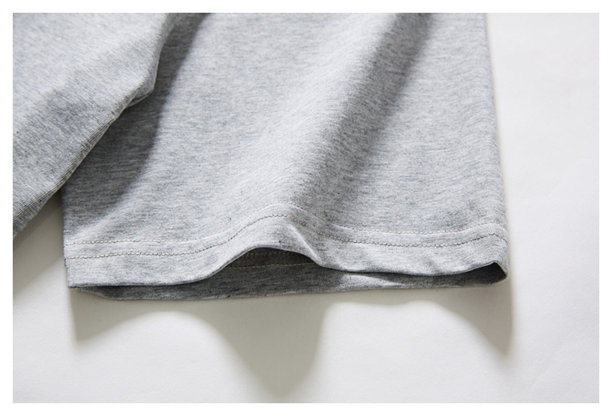Close-up of the heather gray T-shirt sleeve and double-stitched hem.
