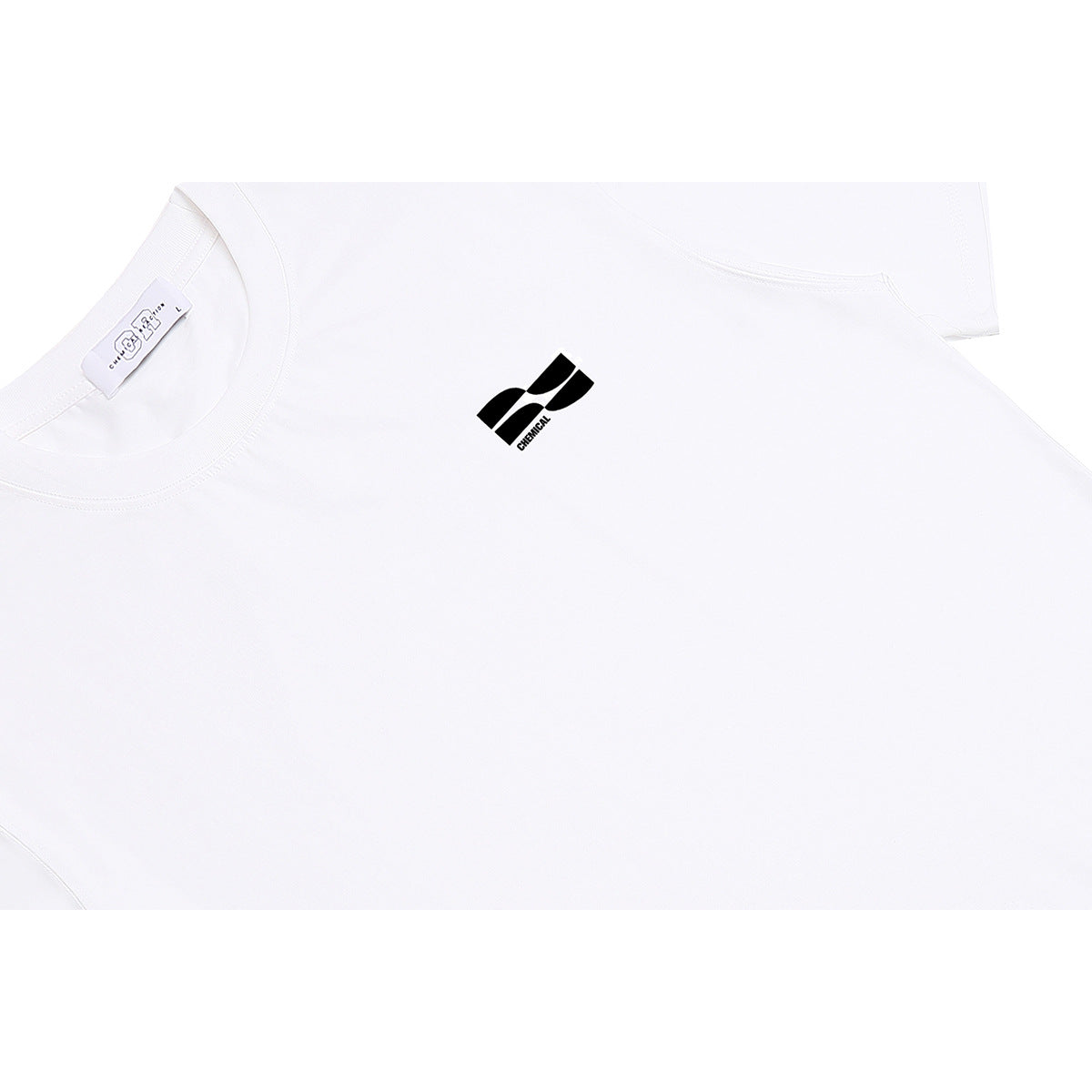 Close-up of a white T-shirt showing its crew neckline, neck label, and small black chest logo.