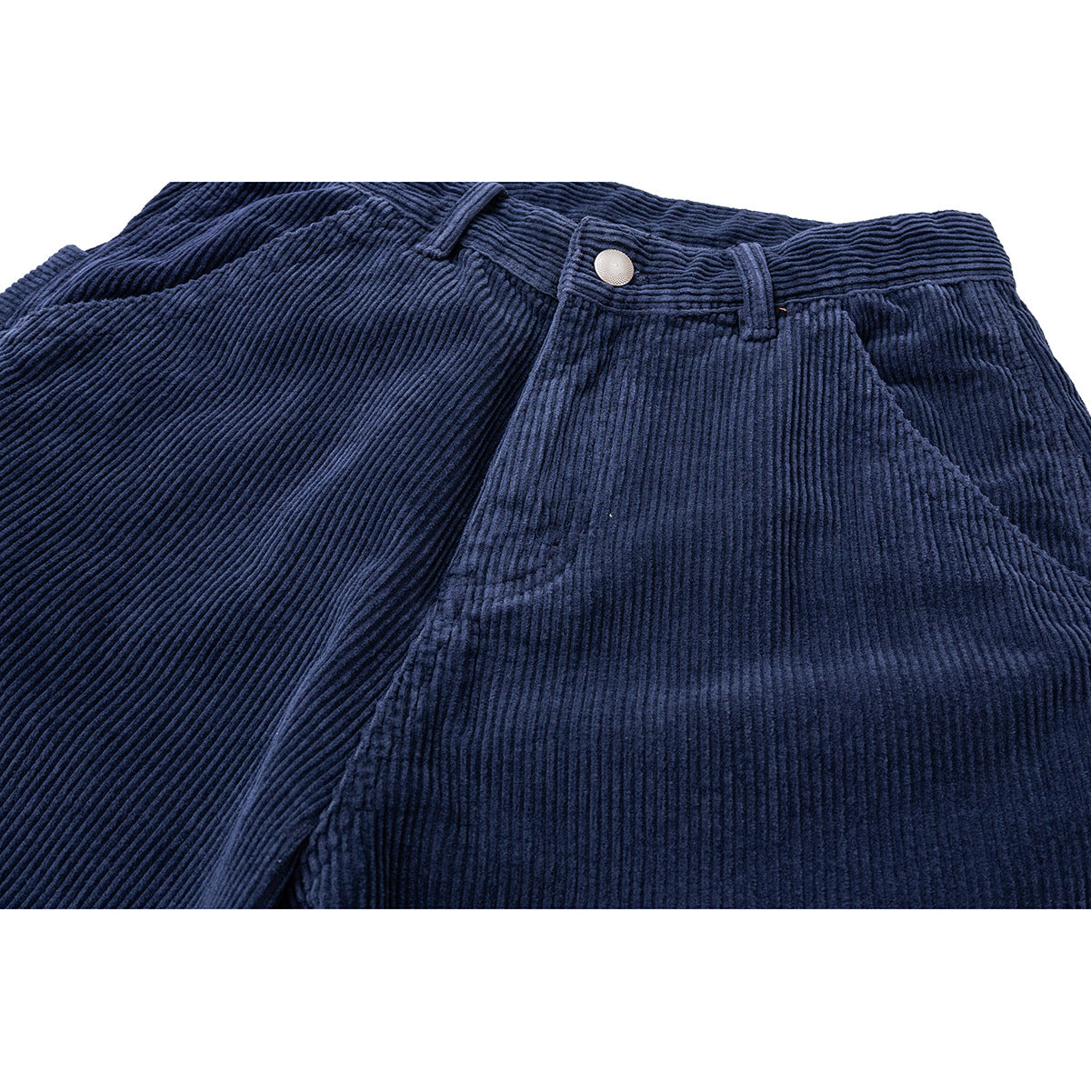 Close-up of navy corduroy shorts showing the waistband, metal button, belt loops, and angled front pocket.