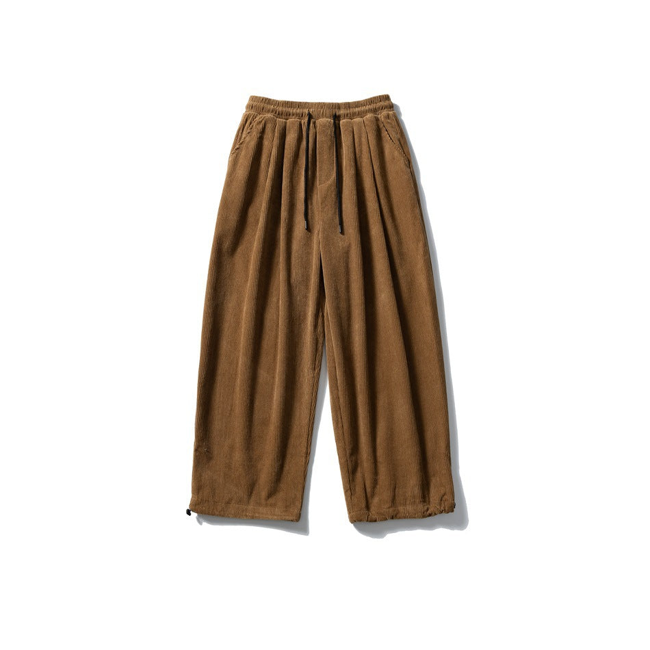Brown corduroy wide-leg pants with drawstring elastic waist, front pleats and hem toggles, flat lay front view