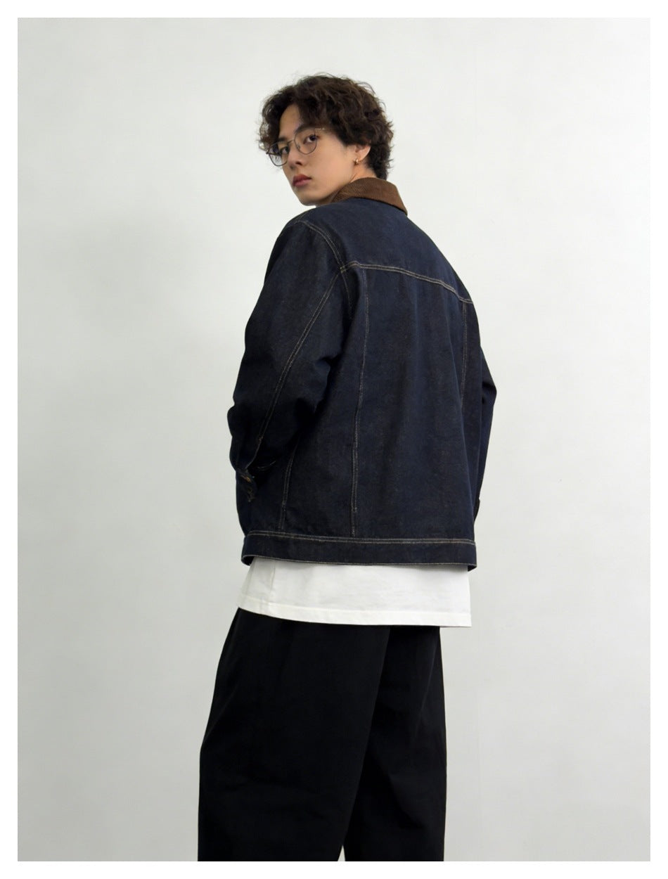 Model wearing dark denim jacket with brown collar, back view showing yoke and seams, looking over shoulder