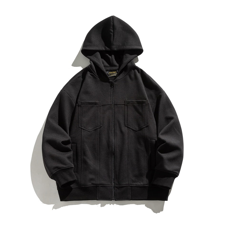 Black waffle-knit zip-up hoodie with chest flap pockets and ribbed cuffs, flat lay front view