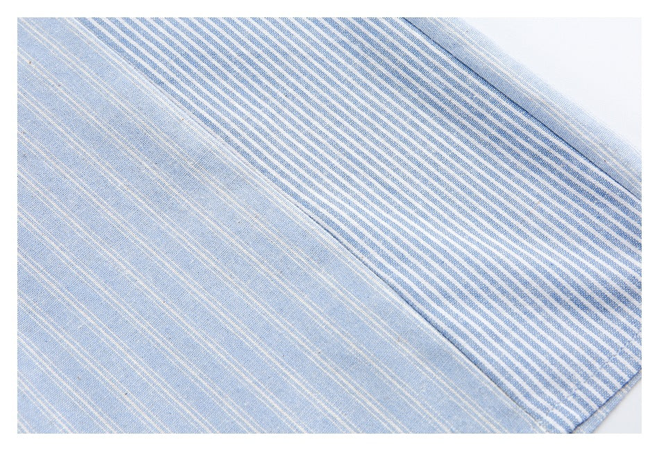 Close-up of light blue fine stripes beside a contrasting blue-and-white striped fabric panel and seam.
