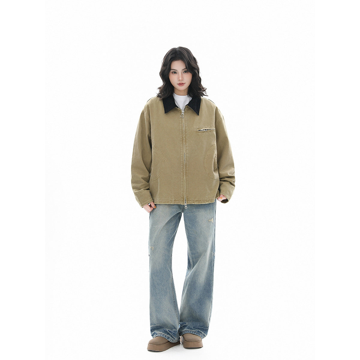 Full-length model wearing a khaki jacket with black collar, paired with loose blue jeans and brown shoes.