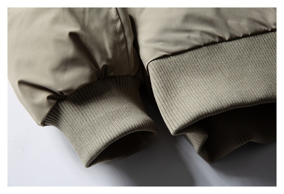 Close-up of a taupe jacket's ribbed knit cuffs and stitched sleeve seams.