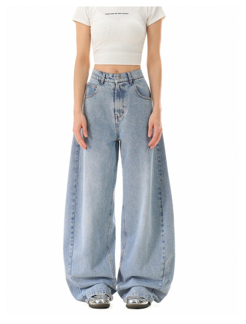 Model wearing light-blue wide-leg barrel jeans with a white cropped tee, front view