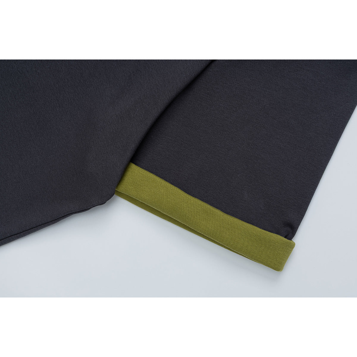 Close-up of a charcoal short sleeve finished with an olive-green cuff.