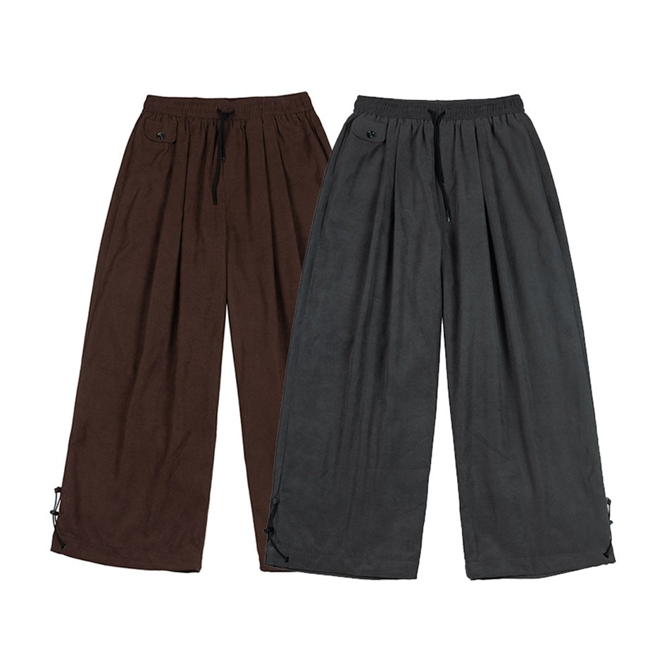 Two pairs of wide-leg pants in brown and charcoal, with elastic drawstring waists and adjustable ankle cords.