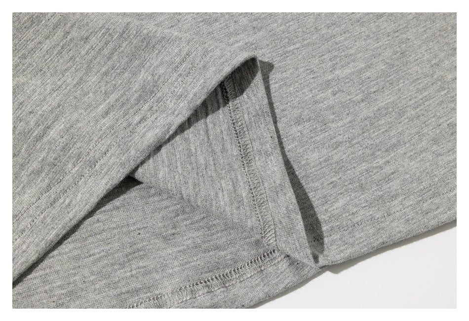 Close-up of the heather gray T-shirt's inside seam and overlocked stitching.