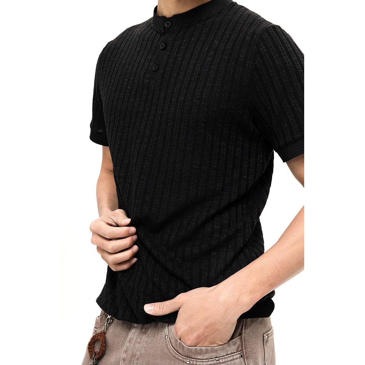 Close-up of a black ribbed short-sleeve henley with a short button placket and band collar.