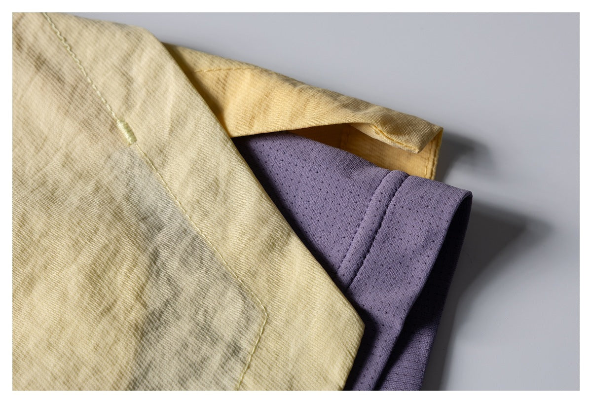 Close-up of pale yellow patterned fabric layered over a lavender perforated panel.