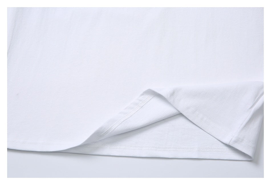 Close-up of a white shirt hem folded back to show the stitching.