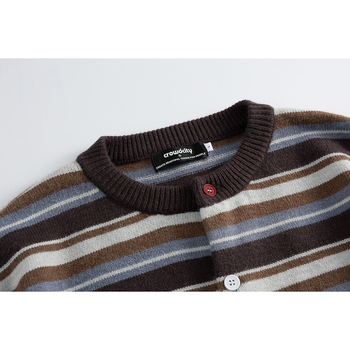Close-up of a brown striped cardigan neckline, red top button, and sewn-in brand label.
