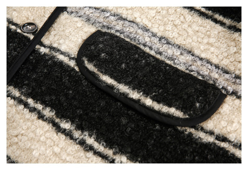 Close-up of a black-edged rectangular pocket on the jacket’s striped fabric.