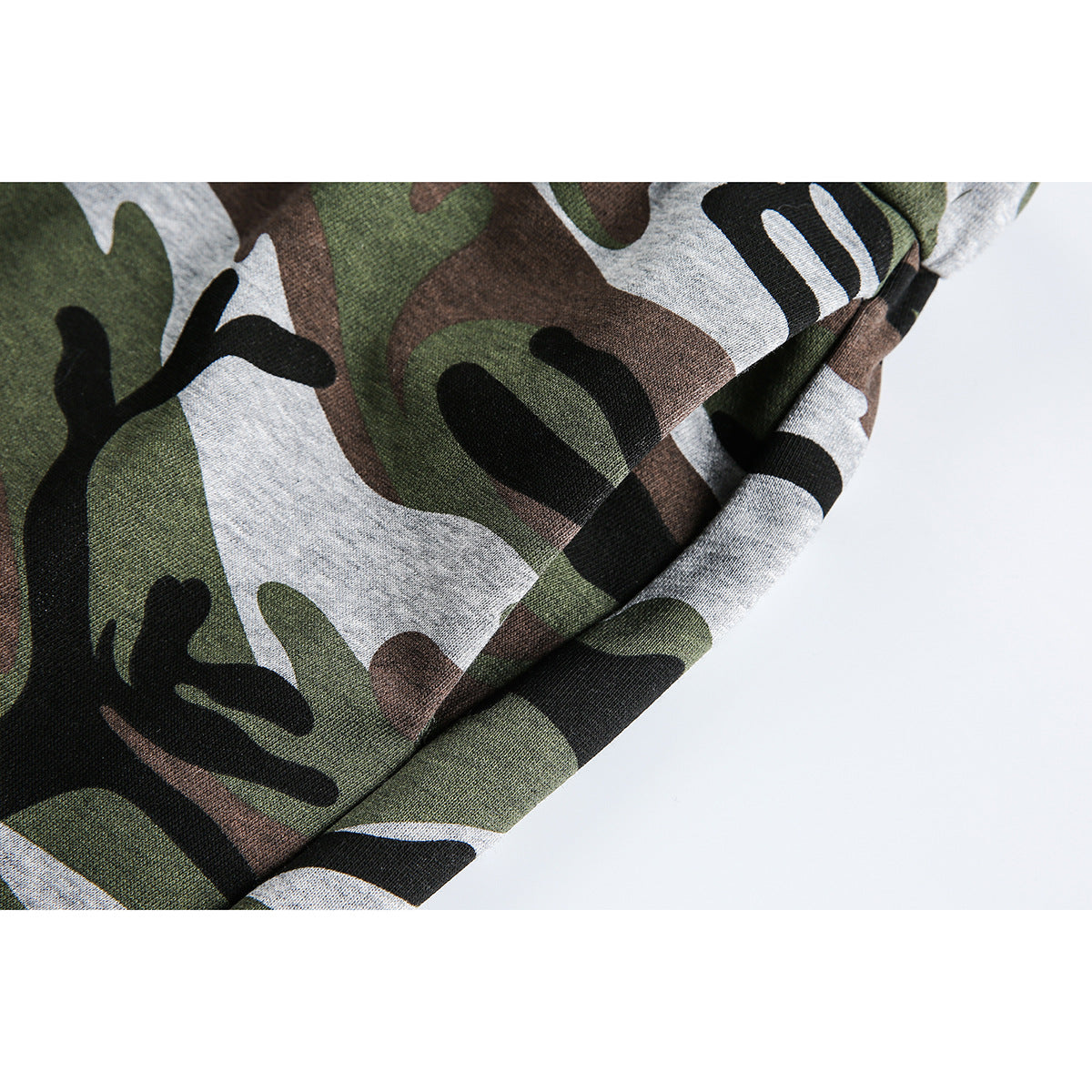 Close-up of camouflage fabric and a stitched seam on the skirt.
