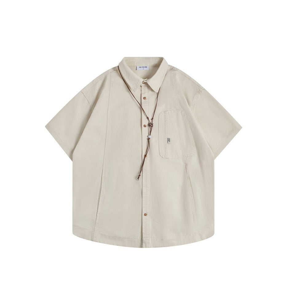 Khaki short-sleeve button-up shirt, front flat lay, with chest pocket and brown cord necklace