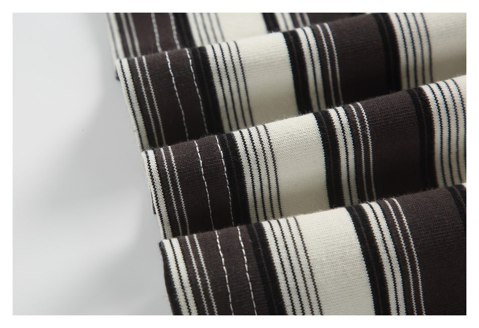 Close-up of cream and dark brown striped knit fabric with stitched edges.