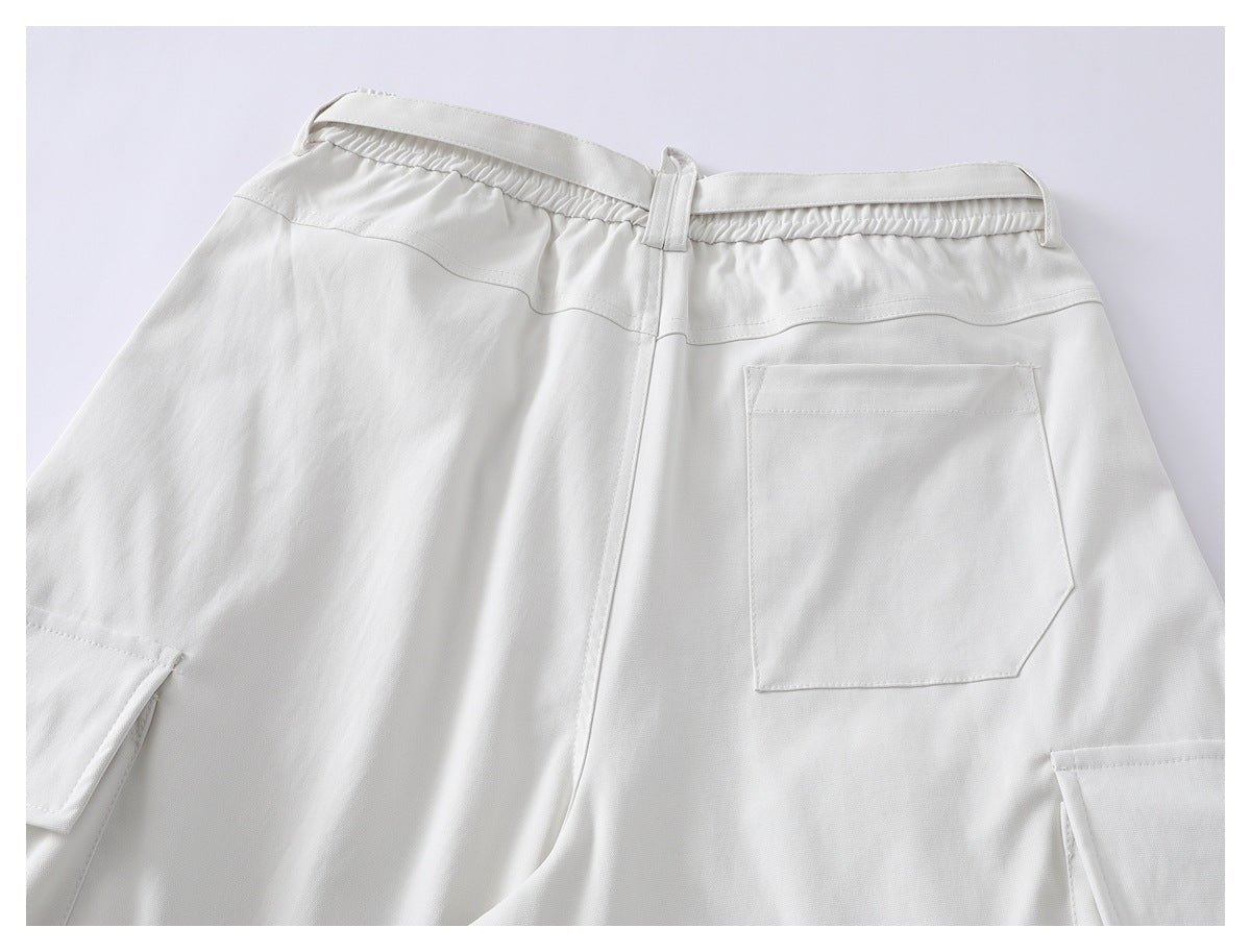 Back view of white shorts with an elastic waistband, a rear patch pocket, and side cargo pockets.