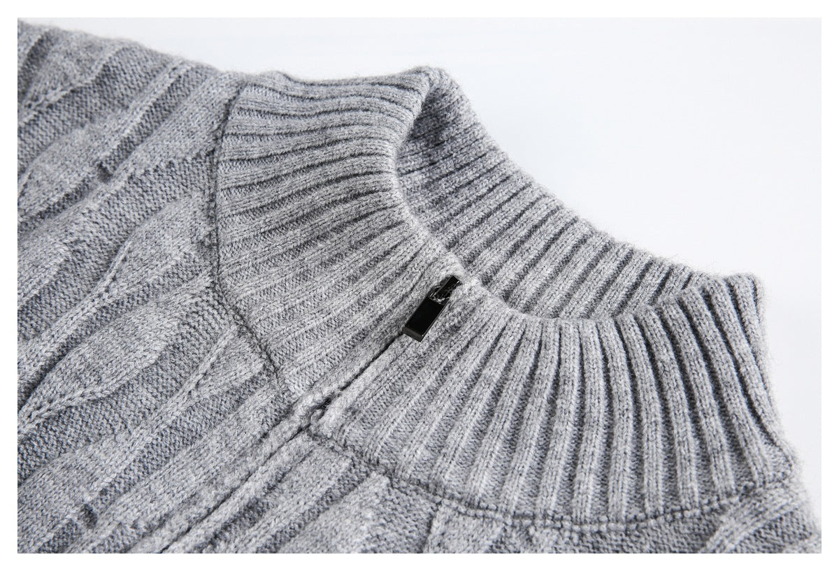 Close-up of a gray sweater's ribbed stand collar, short zipper, and cable-knit stitching.