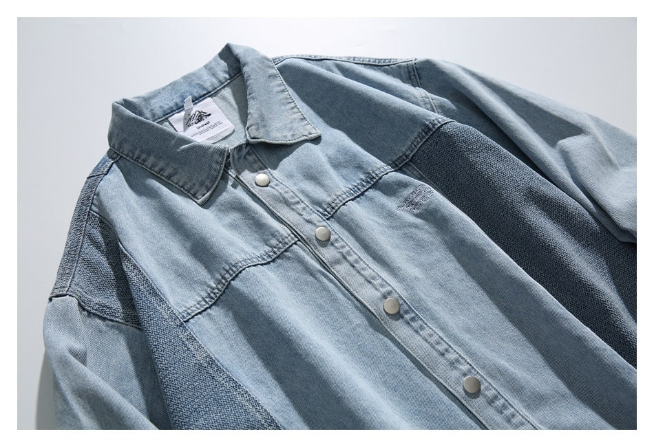 Close view of the light blue denim jacket's front, showing snap buttons, collar, and darker textured panels.