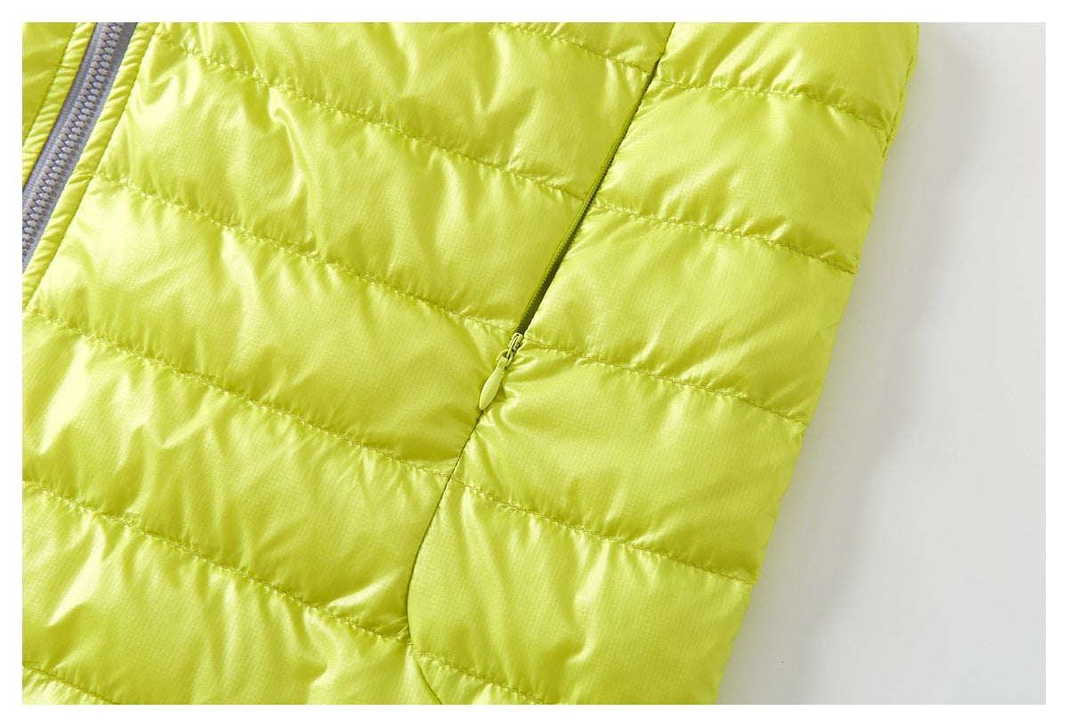 Close-up of the chartreuse vest's quilted side panel and a narrow side zipper.