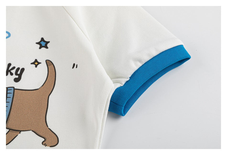 Close-up of a white shirt sleeve with a bright blue ribbed cuff and part of a printed cartoon graphic.