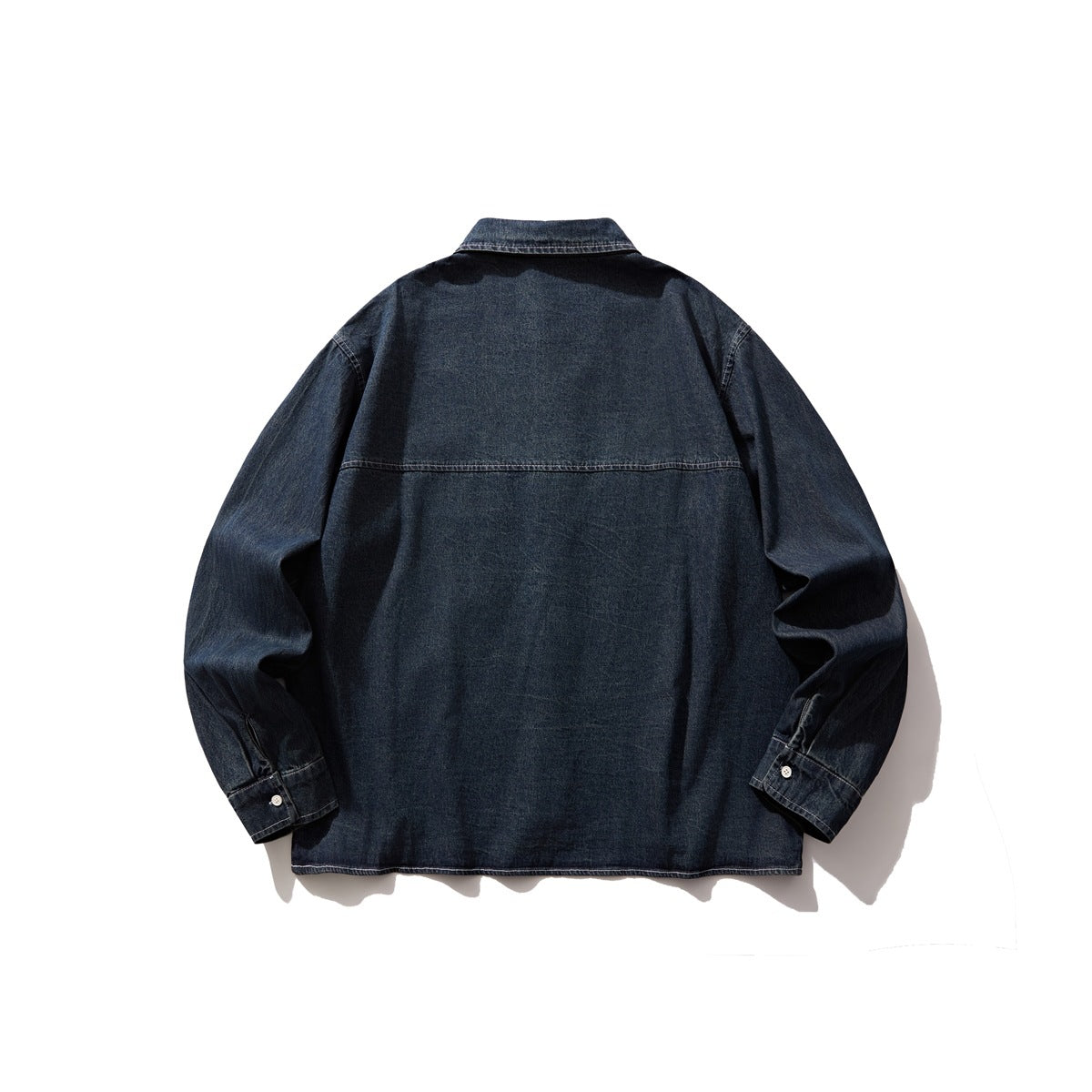 Back view of a dark indigo denim button-up shirt with long sleeves and a horizontal yoke seam.