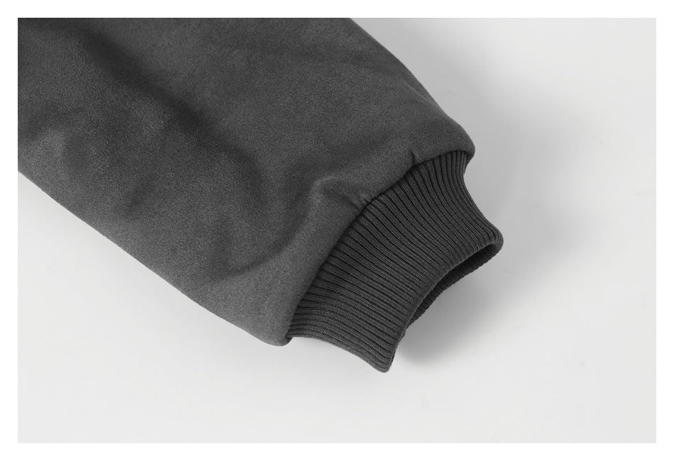 Close-up of a dark sleeve ending in a ribbed knit cuff.