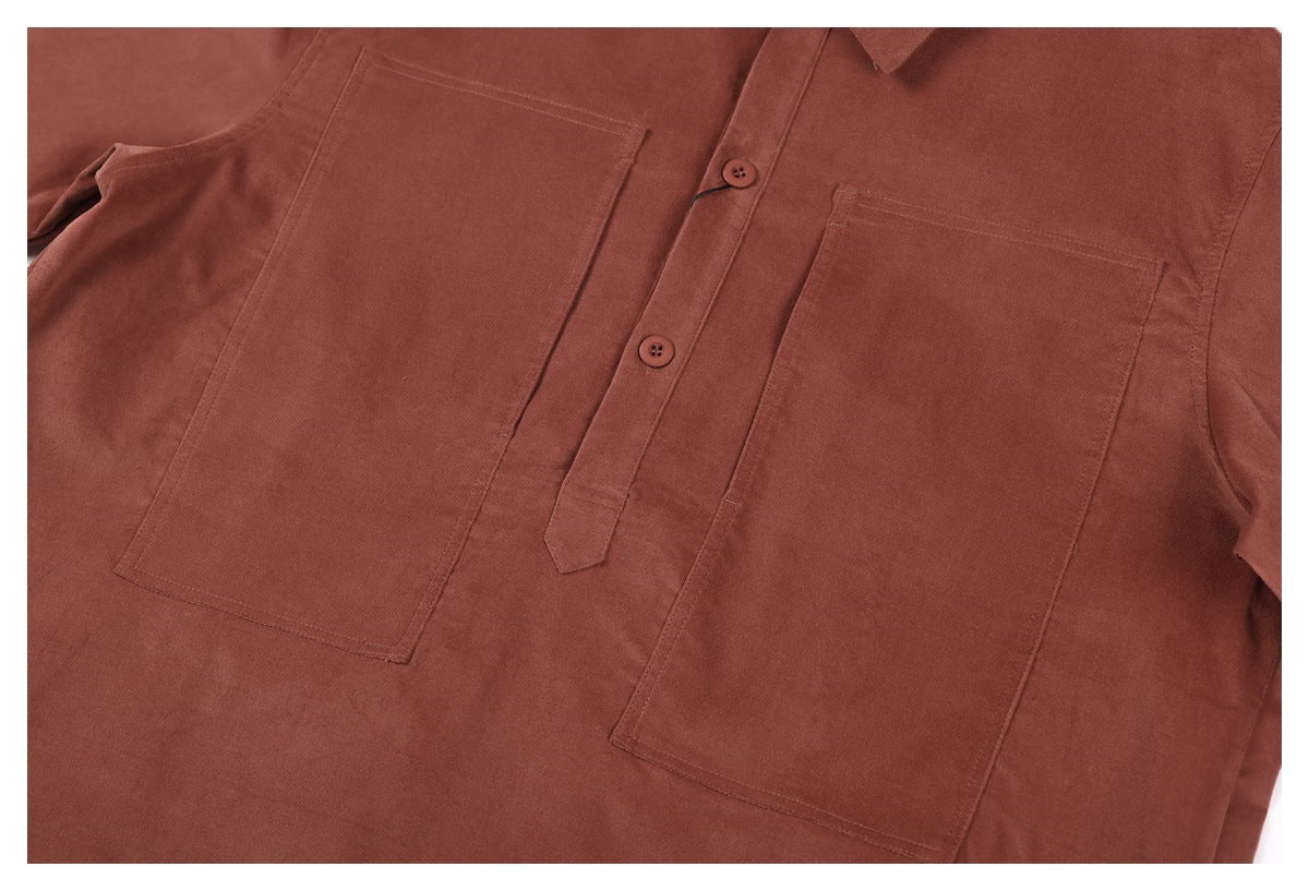 Flat lay of a rust-brown button-front shirt with two large chest pockets.