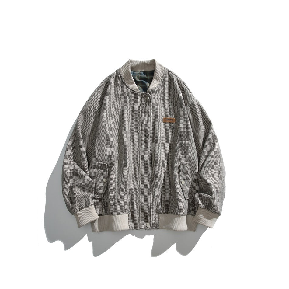 Gray herringbone bomber jacket with a front closure, two snap-flap pockets and white ribbed trim.