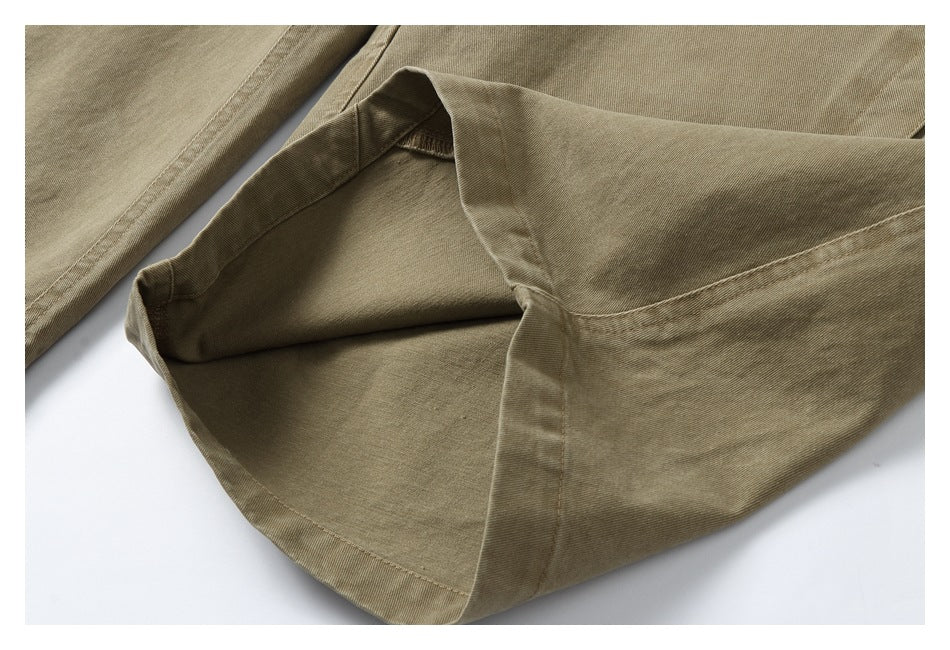 Close-up of a turned-up khaki trouser leg showing the inside and hem stitching.