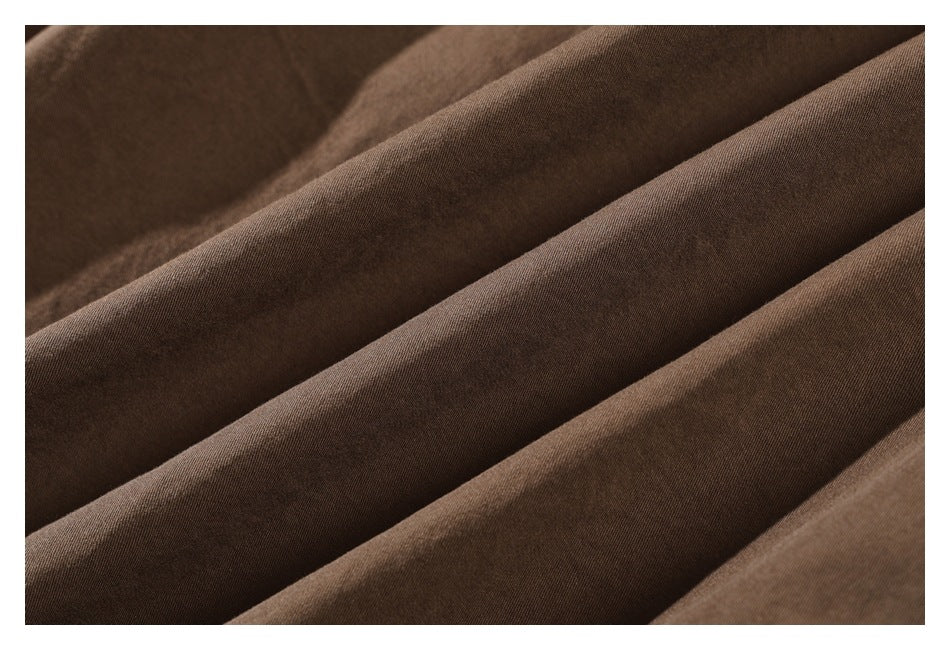 Close-up of brown fabric arranged in soft folds.