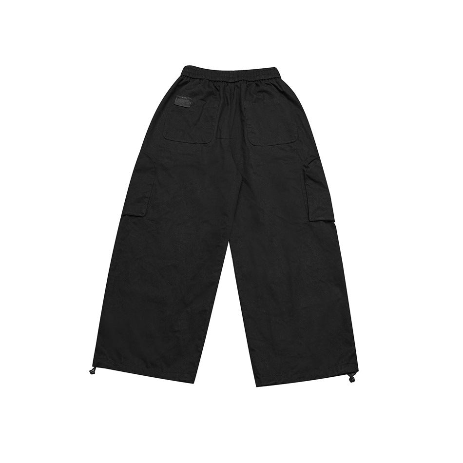 Full rear view of black wide-leg cargo pants with an elastic waistband, two back pockets, side cargo pockets, and hem