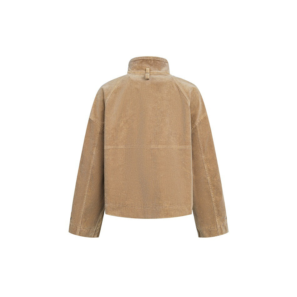 Back view of a tan cropped jacket with a raised collar, raglan sleeves and a horizontal seam across the back.