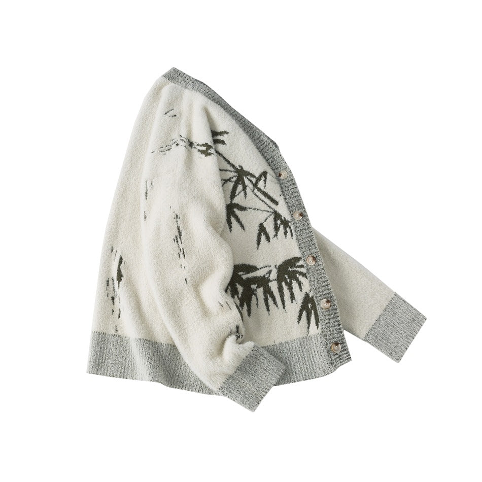 Ivory button-front cardigan with gray ribbed trim and dark bamboo-like motifs, shown flat on white.
