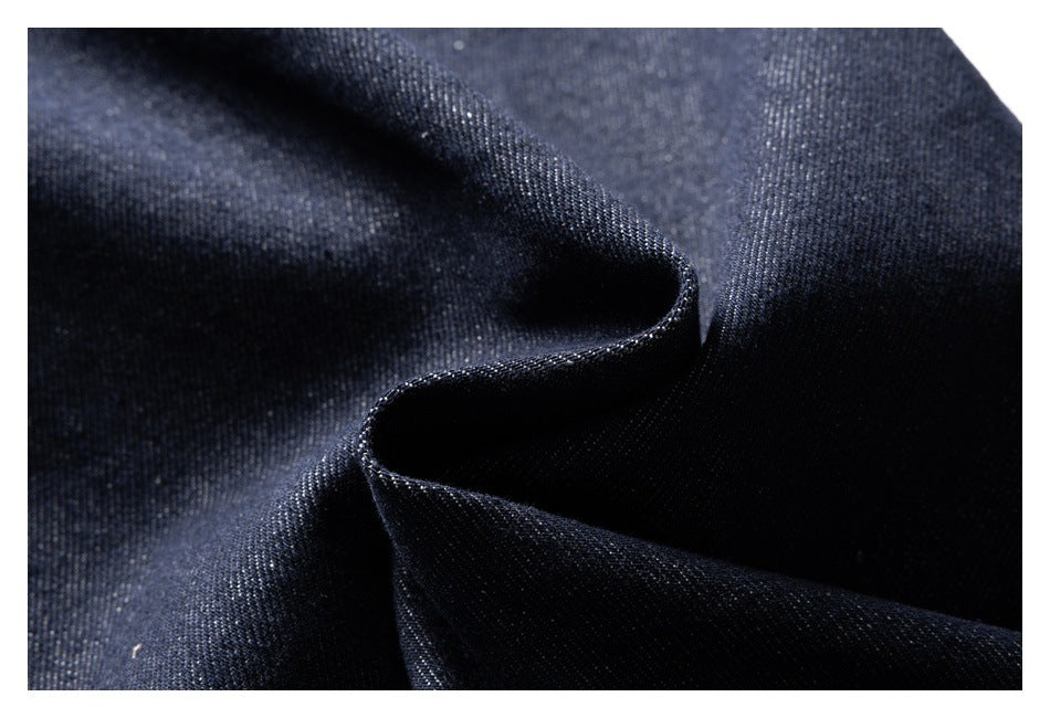 Close-up of dark indigo denim folded to show the fabric texture and edge.