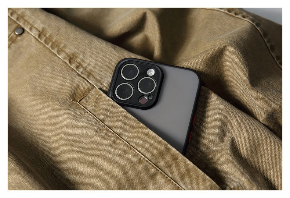 A smartphone tucked into a pocket on a tan-brown jacket, showing the pocket opening and snap.