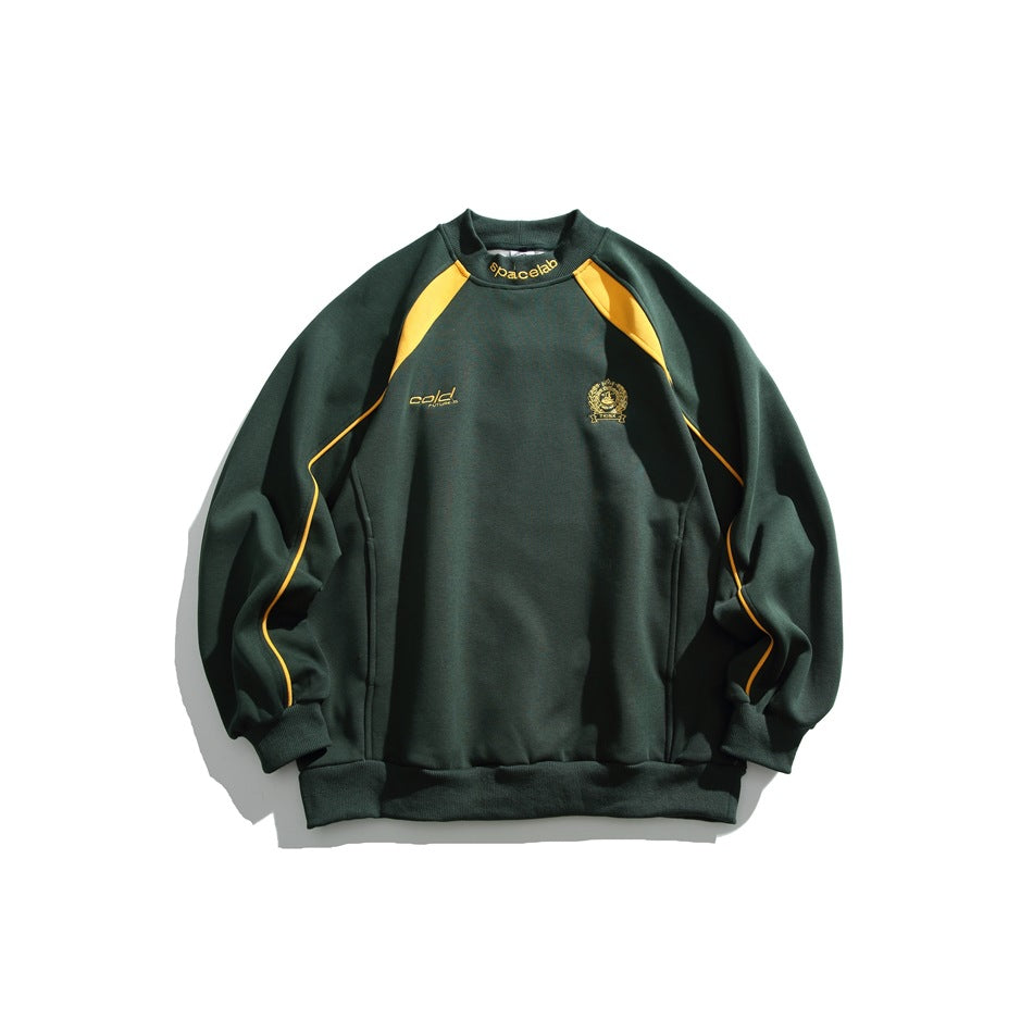 Dark green crewneck sweatshirt with yellow shoulder panels and sleeve piping, plus small gold chest emblems.