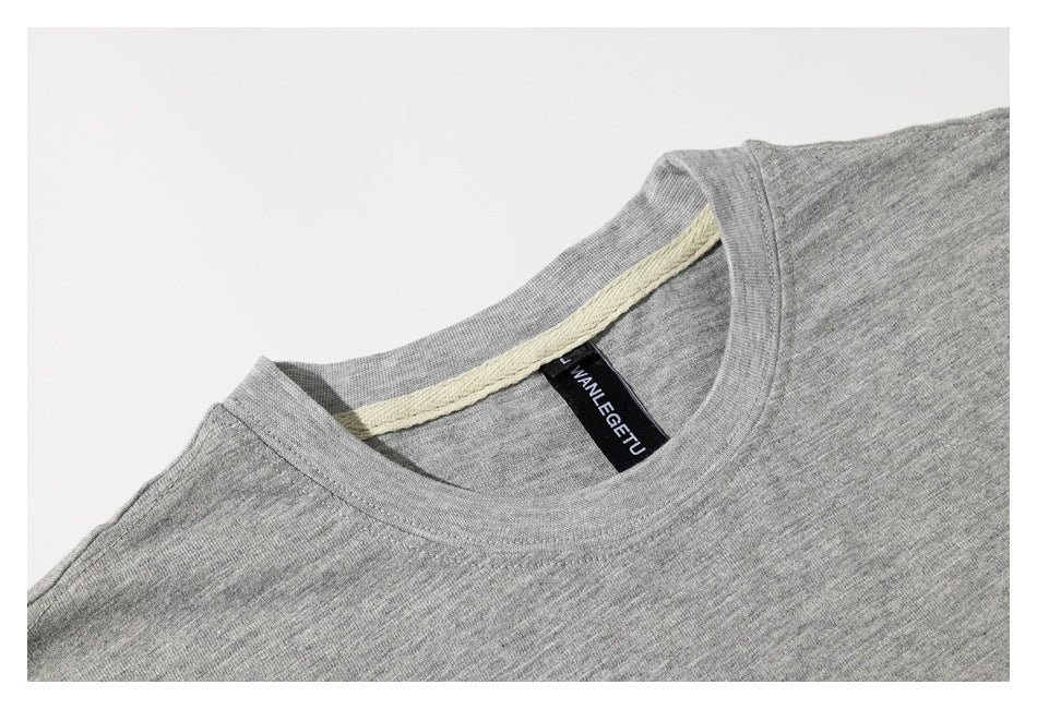 Close-up of a heather gray T-shirt's crew neck, inner trim, and sewn black neck label.