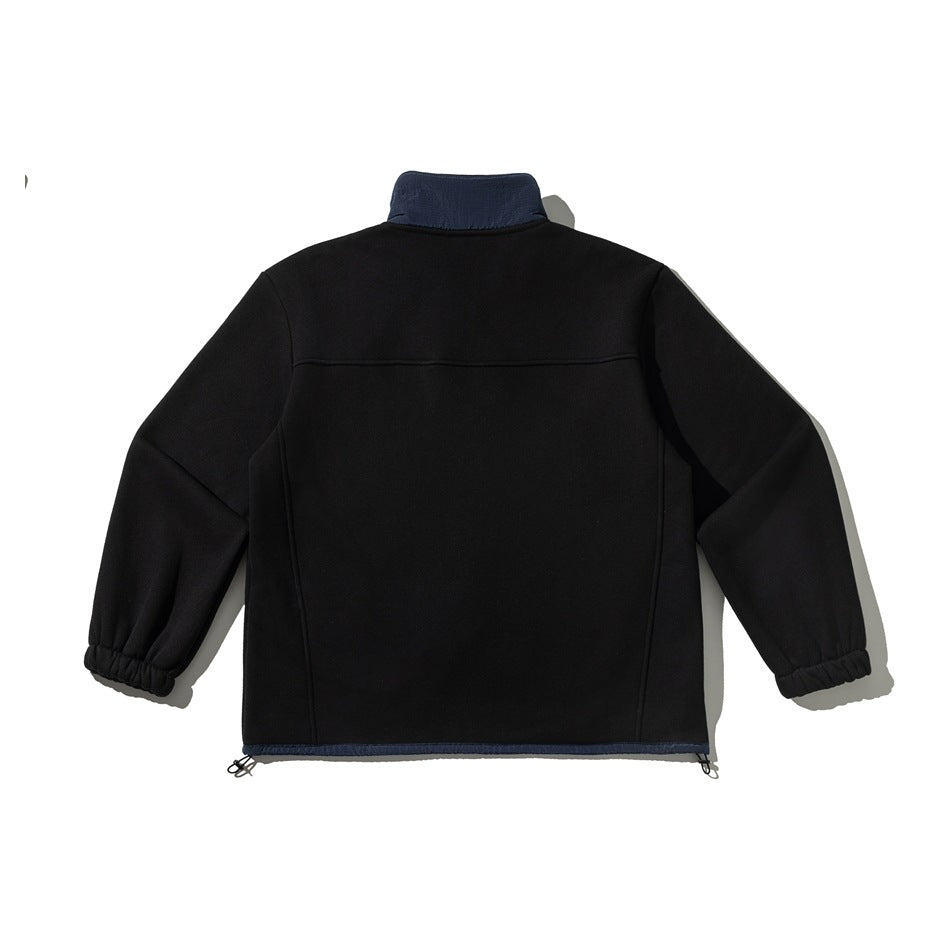 Back view of a black pullover with a navy stand collar, elastic cuffs, and navy hem trim.